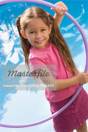 Portrait of a girl holding a plastic hoop and smiling
