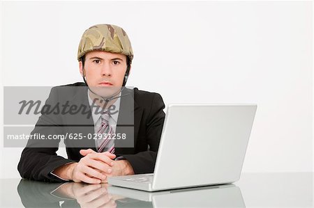 Portrait of a businessman wearing an army helmet