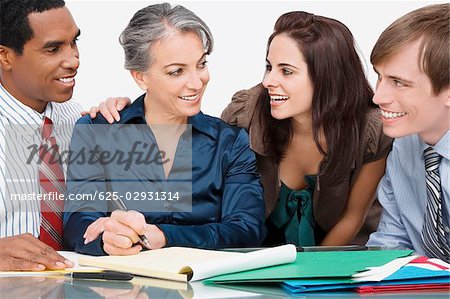 Business executives sitting in a conference room and smiling