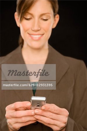 Close-up of a businesswoman text messaging