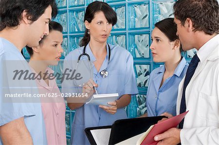 Doctors and nurses discussing medical records