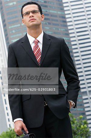 Close-up of a businessman standing with his hand in his pocket
