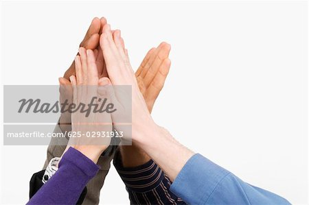 Close-up of business people's hand giving high-five