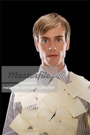 Portrait of a businessman covered with adhesive notes