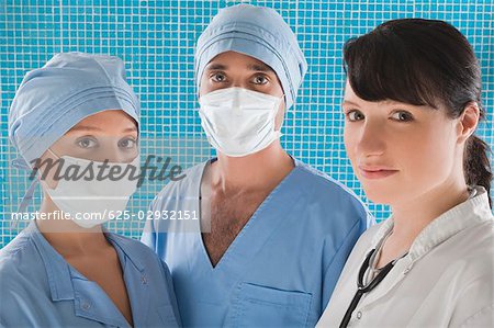 Portrait of a female doctor with two surgeons