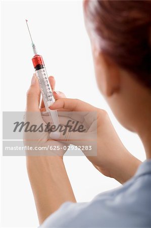 Close-up of a person holding a syringe