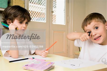 Boy and a girl sitting at a table in a classroom