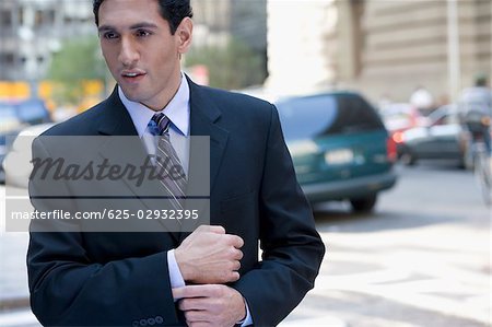 Close-up of a businessman thinking at the roadside