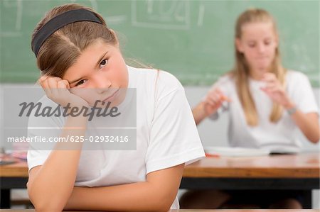 Close-up of a schoolgirl thinking in a classroom