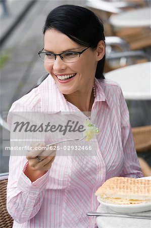 Close-up of a businesswoman having a lunch at a sidewalk cafe