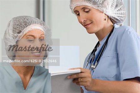 Two female surgeons discussing a medical report