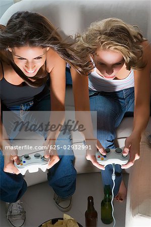 High angle view of two young women playing a video game together