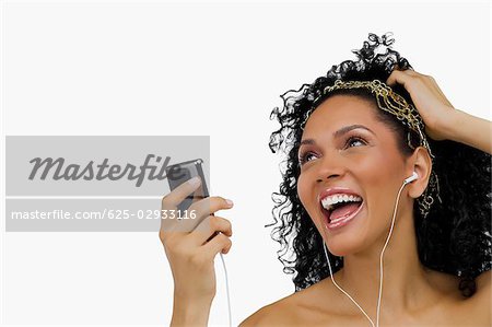 Close-up of a young woman listening to an MP3 player