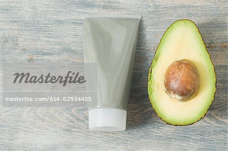 Tube of face mask and avocado