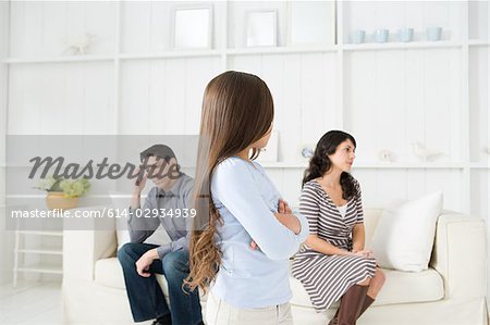 Girl looking at her hostile parents