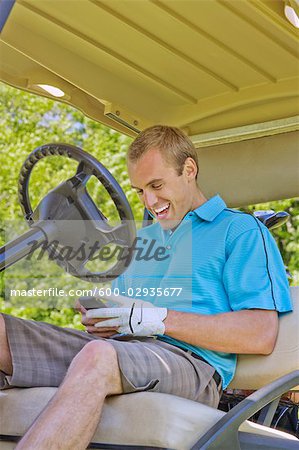 Homme au Golf Cart lecture Message texte