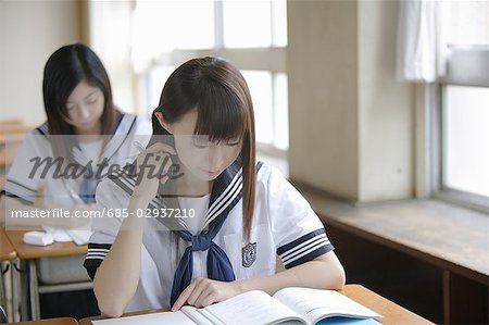 Two high school girls studying