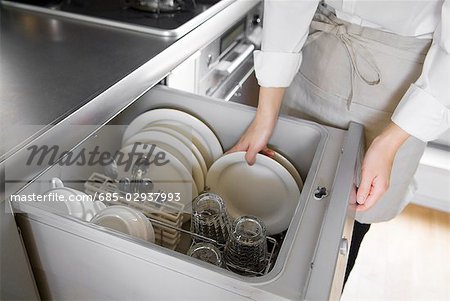 A woman loading dishwasher