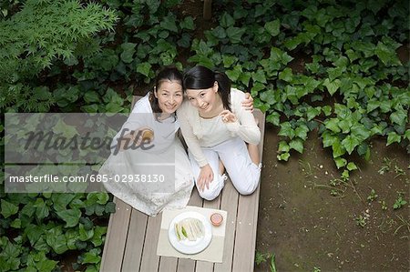 Mother and daughter eating lunch in porch