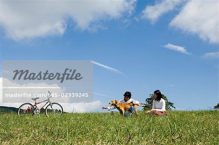 Young couple playing with dog