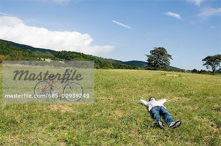 Jeune homme couché sur le champ