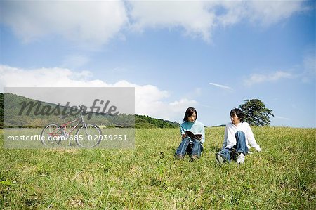 Young couple sitting on field