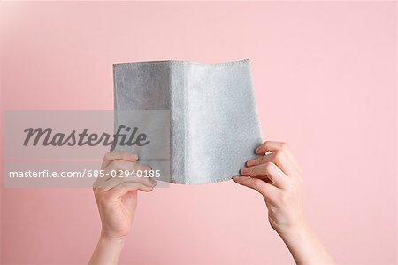 Woman's hands holding book