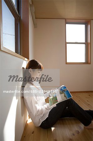 Young woman reading magazine