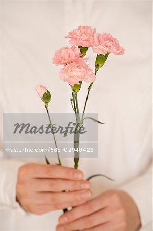 Young woman holding carnation