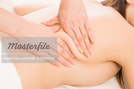 Massage therapist applying body massage