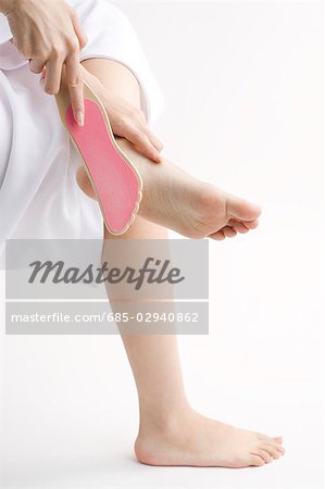 Young woman rubbing foot