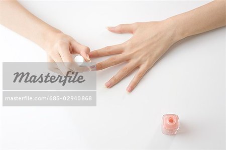 Young woman painting manicure