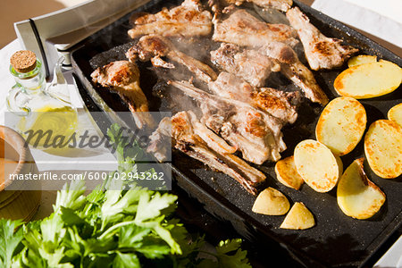 Meat and Potatoes Cooking on an Electric Grill