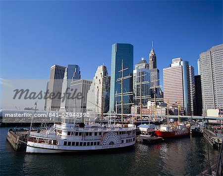 Boats in the harbour at South Street Sea Port, with the city skyline in the background, in New York, United States of America, North America