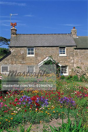 Stone cottage and colourful garden at New Grimsby on Tresco in the Scilly Isles, England, United Kingdom, Europe