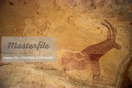 Huge painting of god figure and sable antelope on rock wall, Tassili Plateau, Algeria, North Africa, Africa