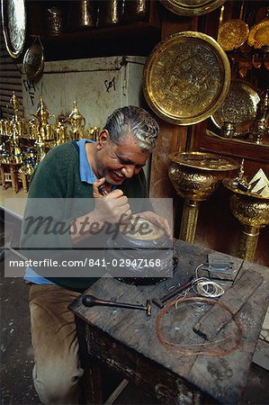 Portrait of a craftsman at work in a copper souk, Khan el Khalili Bazaar, Cairo, Egypt, North Africa, Africa