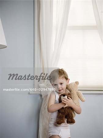 boy holding his teddy bears