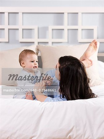 mother and baby on a bed