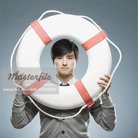 man looking through the hole of a life preserver