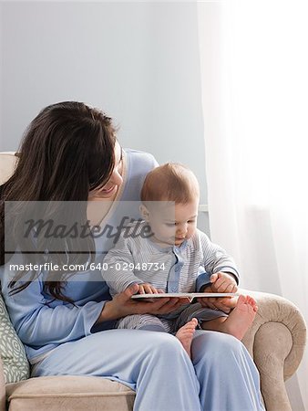 mother reading a book to her baby