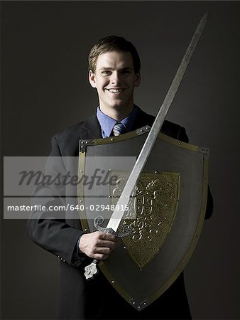businessman holding a sword and shield