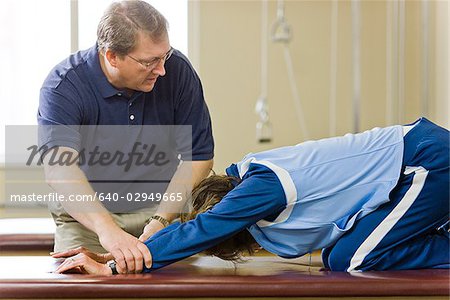 physical therapist working with a woman