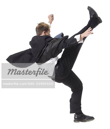 businessman doing a karate kick