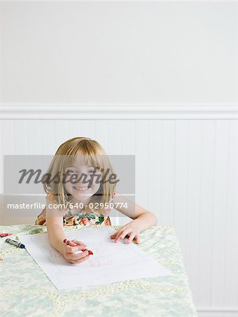 girl drawing at the kitchen table