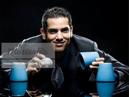 businessman playing the cup game