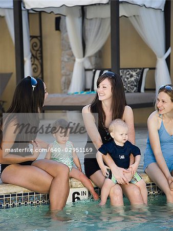 women by the pool with their babies