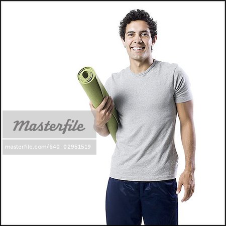 man holding a yoga mat