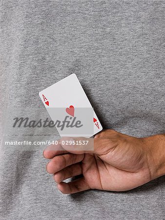 man holding an ace card behind his back