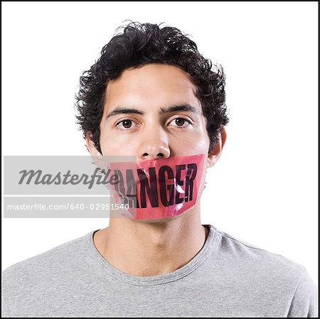 man with danger tape over mouth